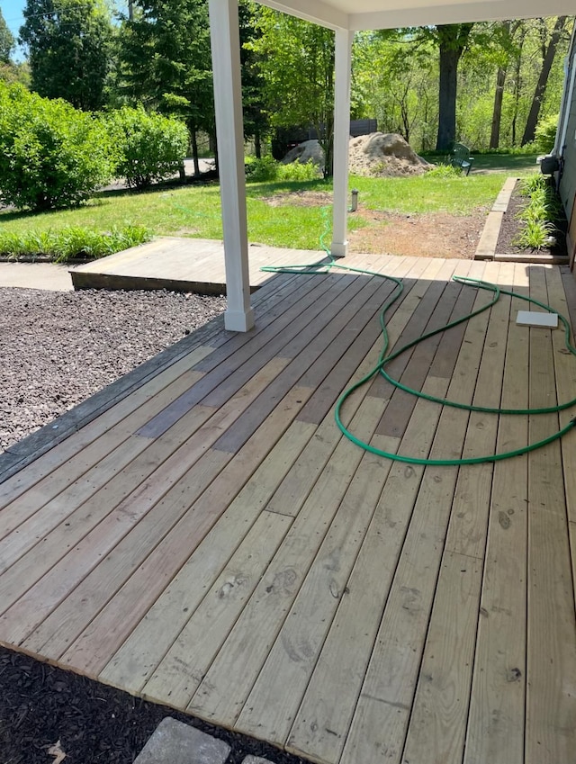 wooden deck with a lawn