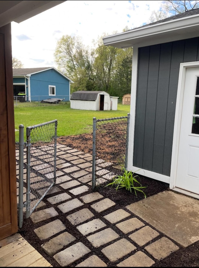 view of patio / terrace with a shed, fence, and an outdoor structure