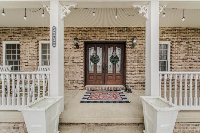 5050 Pleasant Lake Rd, Ann Arbor, MI 48103 - property entrance featuring covered porch and brick siding