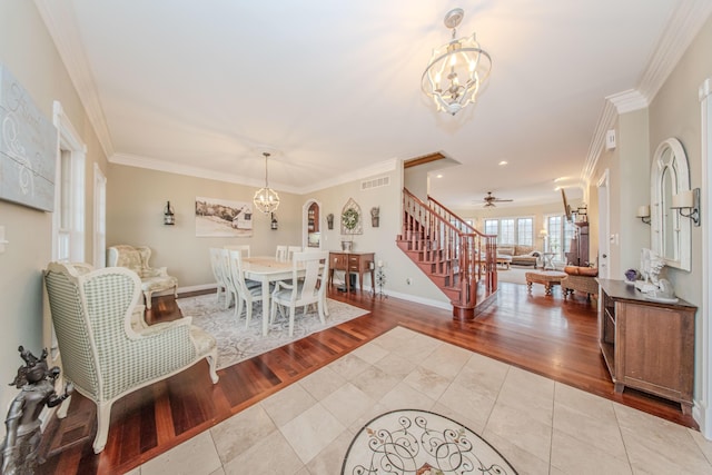 5050 Pleasant Lake Rd, Ann Arbor, MI 48103 - dining space with stairway, a chandelier, tile patterned flooring, ornamental molding, and ceiling fan