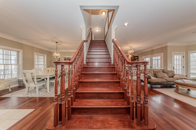 5050 Pleasant Lake Rd, Ann Arbor, MI 48103 - stairway with a chandelier, wood finished floors, plenty of natural light, and crown molding