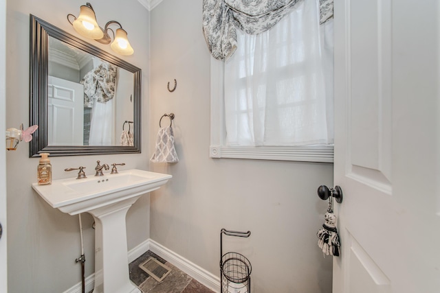 5050 Pleasant Lake Rd, Ann Arbor, MI 48103 - bathroom featuring baseboards and a sink