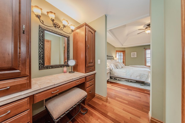 5050 Pleasant Lake Rd, Ann Arbor, MI 48103 - ensuite bathroom featuring wood finished floors, a raised ceiling, a ceiling fan, and vanity