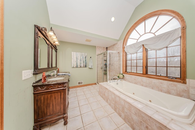 5050 Pleasant Lake Rd, Ann Arbor, MI 48103 - bathroom with vaulted ceiling, a jetted tub, a shower stall, vanity, and tile patterned floors