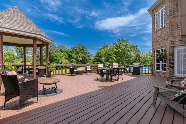 5050 Pleasant Lake Rd, Ann Arbor, MI 48103 - deck featuring outdoor dining space, view of scattered trees, and a pool