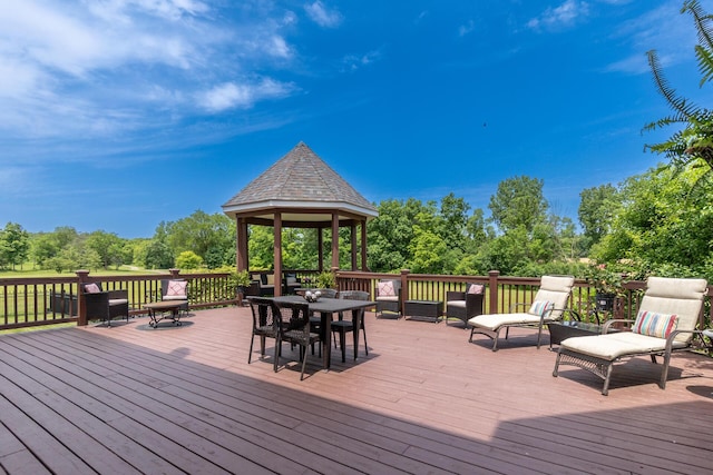 5050 Pleasant Lake Rd, Ann Arbor, MI 48103 - wooden deck featuring a gazebo, outdoor dining area, and view of scattered trees