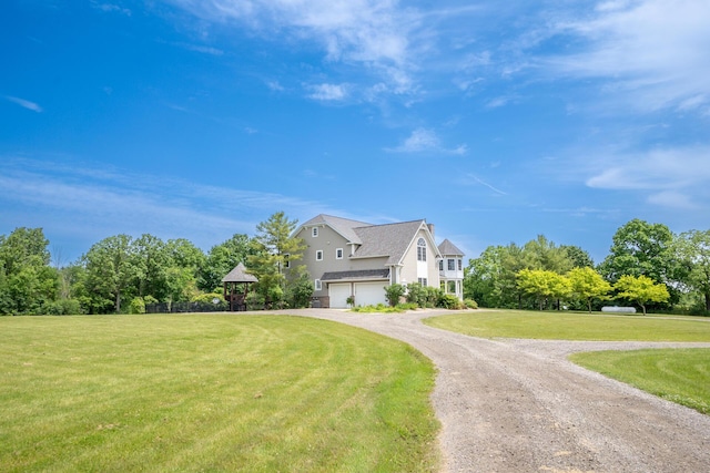 5050 Pleasant Lake Rd, Ann Arbor, MI 48103 - view of side of property featuring a garage, dirt driveway, and a yard