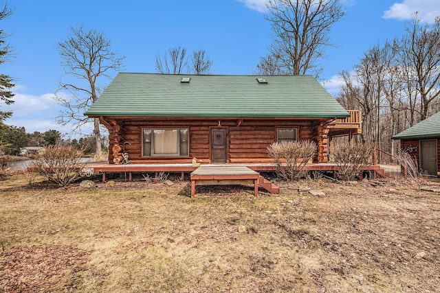 back of property featuring metal roof and log exterior