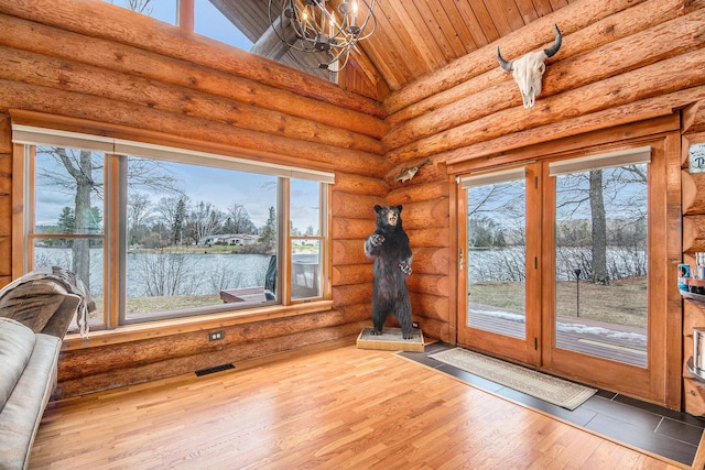 doorway to outside featuring high vaulted ceiling, wood ceiling, visible vents, a notable chandelier, and wood finished floors