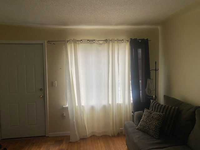 9619 Decatur St, Detroit, MI 48227 - living area featuring a textured ceiling and light wood finished floors