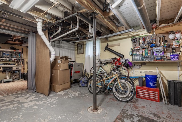 unfinished basement featuring a workshop area
