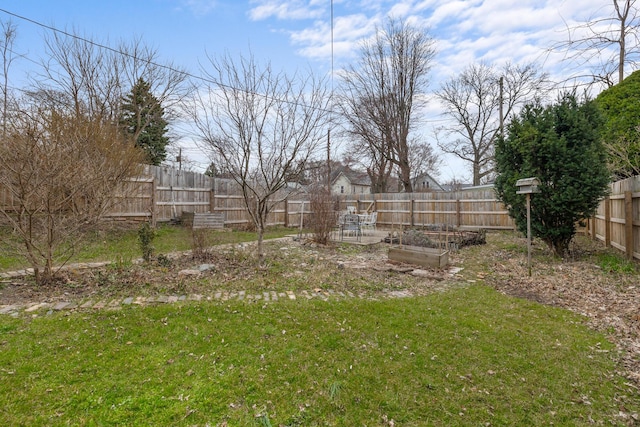 view of yard with a garden and a fenced backyard
