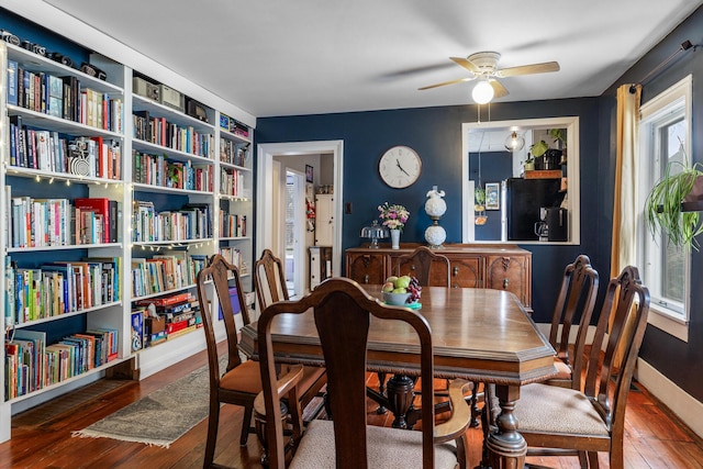 dining room featuring baseboards, ceiling fan, and hardwood / wood-style floors