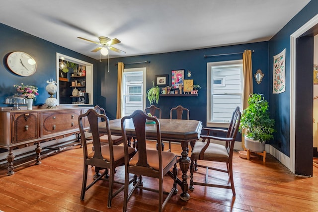 dining space featuring baseboards, ceiling fan, and hardwood / wood-style flooring