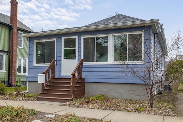 bungalow-style home featuring a shingled roof