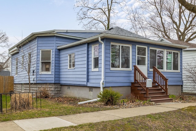 view of front of house with entry steps and fence