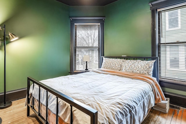 bedroom featuring baseboards and wood-type flooring