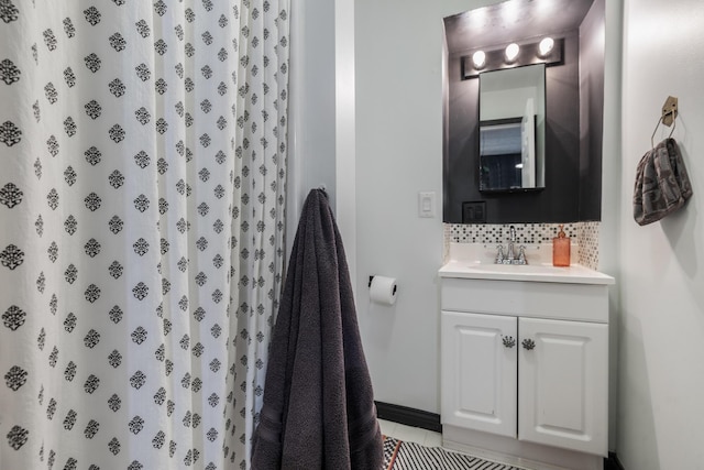 full bath featuring a shower with shower curtain, tile patterned floors, backsplash, and vanity