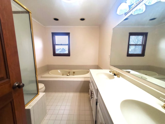 bathroom featuring a jetted tub, tile patterned flooring, and a sink