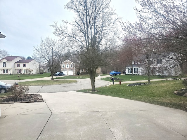 view of street with driveway and a residential view