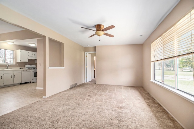 28531 Greening St, Farmington Hills, MI 48334 - empty room featuring baseboards, light carpet, a ceiling fan, visible vents, and a sink