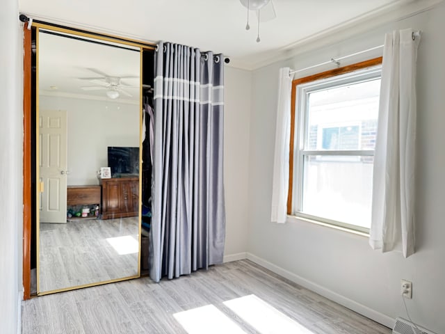 24275 Valley Ave, Eastpointe, MI 48021 - empty room with wood finished floors, ceiling fan, crown molding, and a baseboard radiator