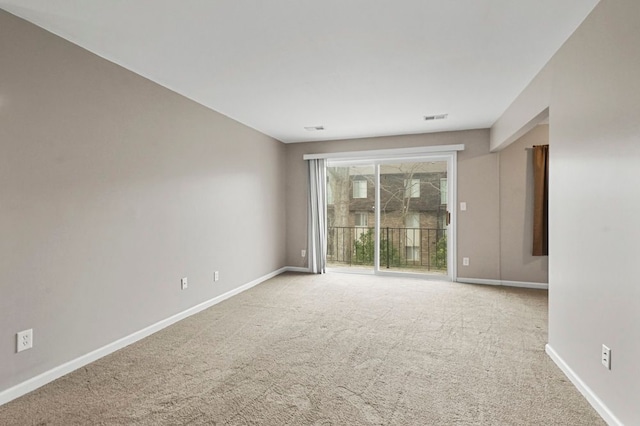 unfurnished room with baseboards, visible vents, and carpet