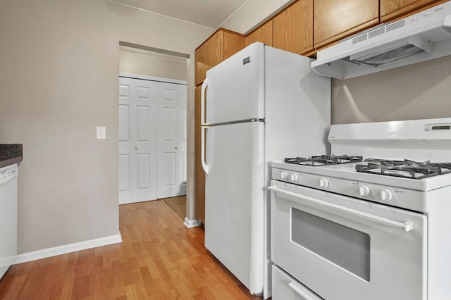 kitchen with light wood-style flooring, baseboards, white gas stove, under cabinet range hood, and brown cabinetry
