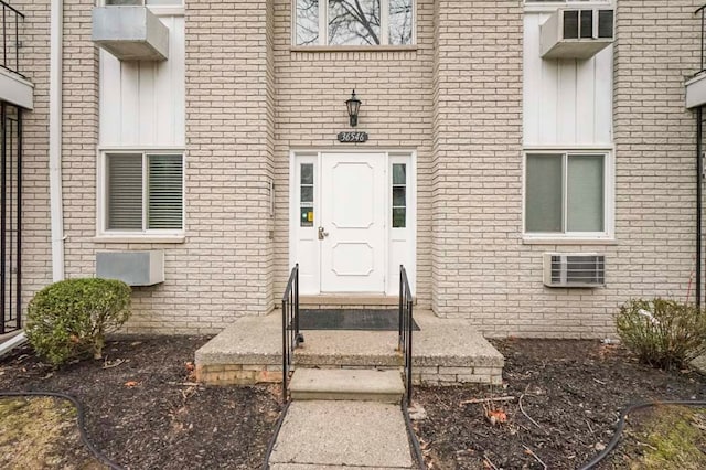 doorway to property featuring brick siding