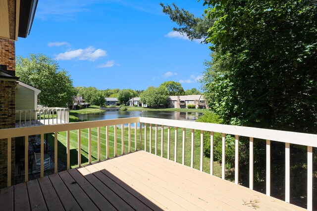 17650 Woodbridge Rd # 1, Spring Lake, MI 49456 - wooden deck with a water view and a yard