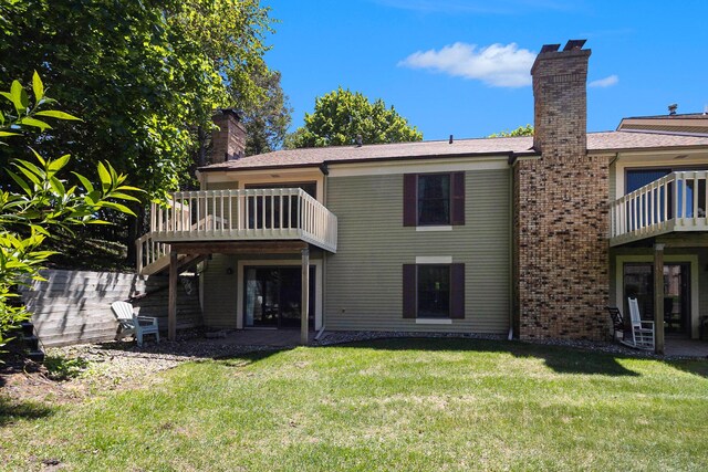 17650 Woodbridge Rd # 1, Spring Lake, MI 49456 - back of property with a chimney, a yard, stairway, and a deck