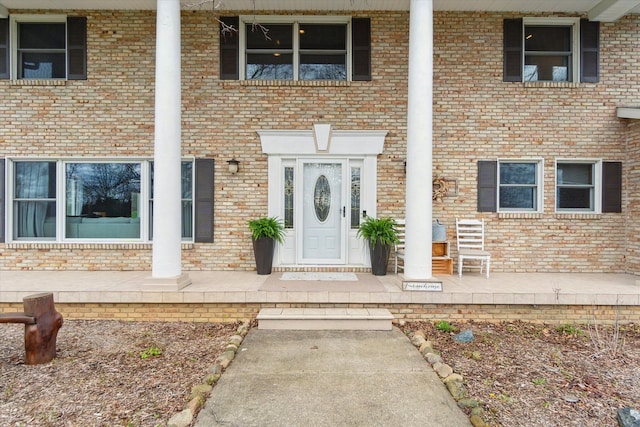 doorway to property with brick siding