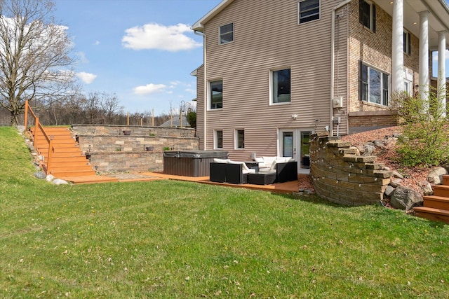 rear view of property with an outdoor hangout area, a hot tub, a yard, a patio, and stairs