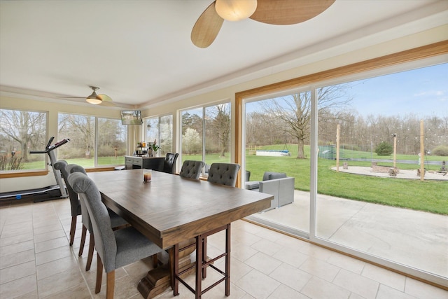 sunroom with tile patterned floors and a healthy amount of sunlight