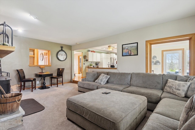 carpeted living room with baseboards