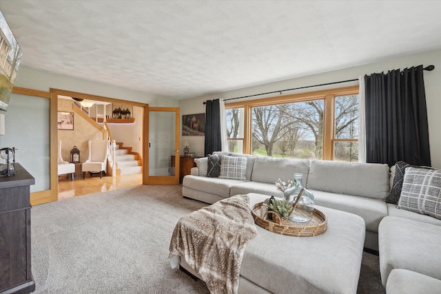 carpeted living room with stairway