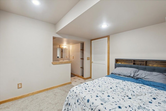 bedroom with light carpet and baseboards