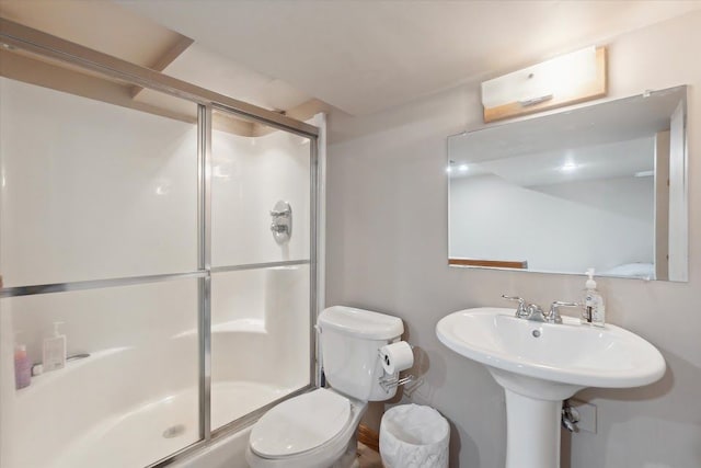 bathroom featuring a shower stall and toilet