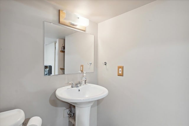 bathroom with toilet and a sink