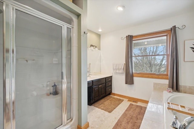 full bath with a tub, vanity, visible vents, a stall shower, and baseboards