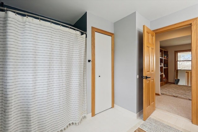 bathroom with tile patterned floors and baseboards