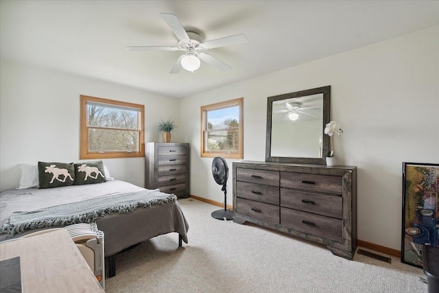 bedroom with multiple windows, baseboards, and carpet floors
