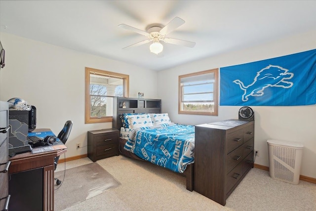 bedroom featuring light carpet, baseboards, and multiple windows
