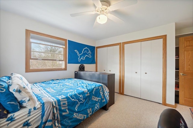 bedroom featuring two closets and ceiling fan
