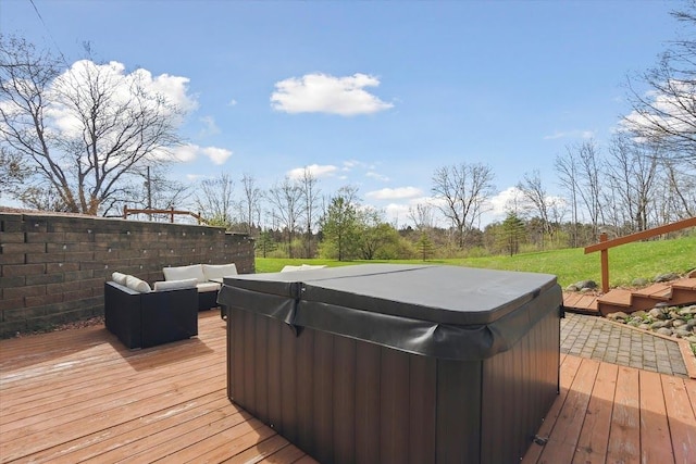 wooden deck with outdoor lounge area and a hot tub