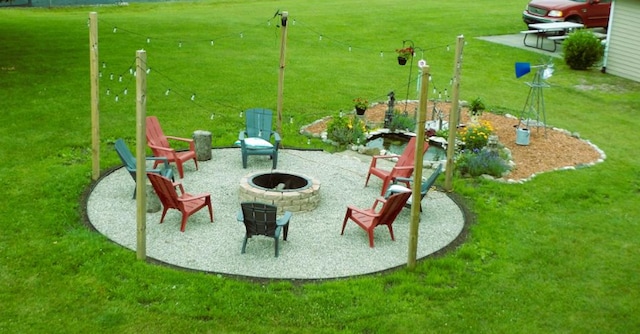 exterior space with a patio area, a fire pit, and a lawn