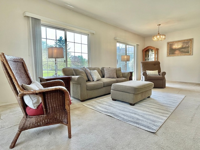 living room with an inviting chandelier and light colored carpet