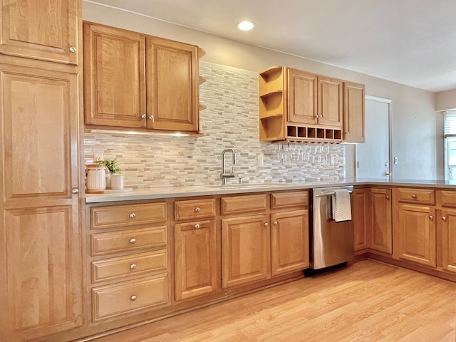 kitchen with a sink, light wood-style floors, open shelves, tasteful backsplash, and dishwasher