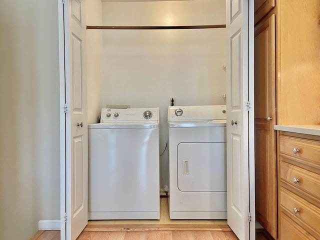 clothes washing area featuring washer and clothes dryer and laundry area