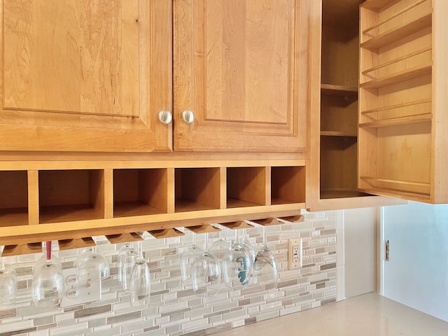 details featuring decorative backsplash and open shelves